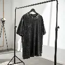 black-acid-wash-oversized-t-shirt-hanging-on-a-min.webp